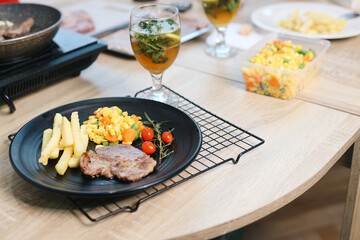 A Plate of Beef Steak with Mint Tea at Wooden Table 