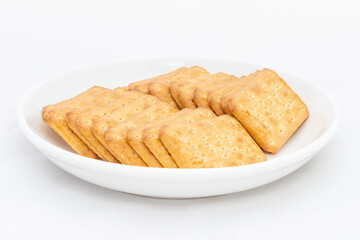 Salty crackers in a plate isolated on white background.