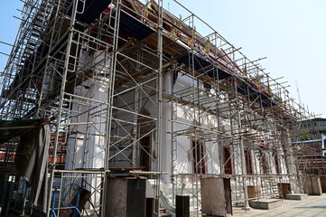 BANGKOK, THAILAND - April 18, 2024 : Thai workers to renovate and restore Thai Buddhist temple at Thailand with Blue Sky Background.