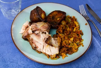 Foto op Plexiglas Portion of baked pork meat with roasted potatoes and stewed cabbage. © JackF