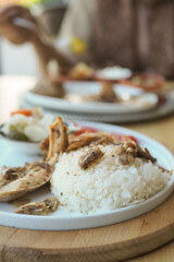 Boiled chicken, steamed rice, pink plate.