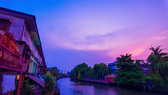 time lapse Clouds float over the canal at beautiful sunset.
A small canal is the route to Wat Paknam, which has a large and beautiful Buddha statue that is one of the landmarks in Bangkok.big Buddha