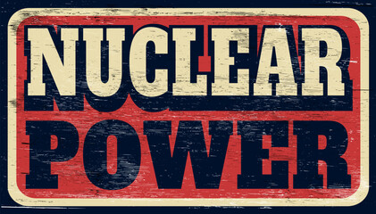 Aged and worn nuclear power sign on wood