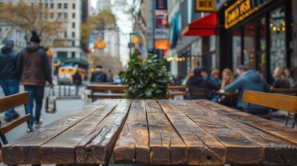 Wooden cafe table on a busy city sidewalk - obrazy, fototapety, plakaty