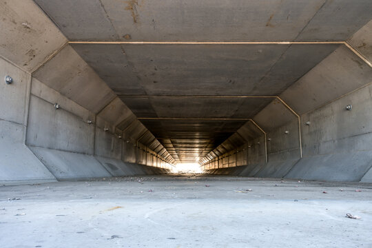 Focus stacked image inside a concrete box culvert under a road for stormwater drainage. 