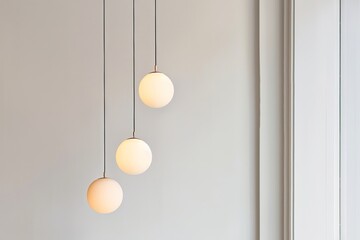 Three white light bulbs hanging from a ceiling