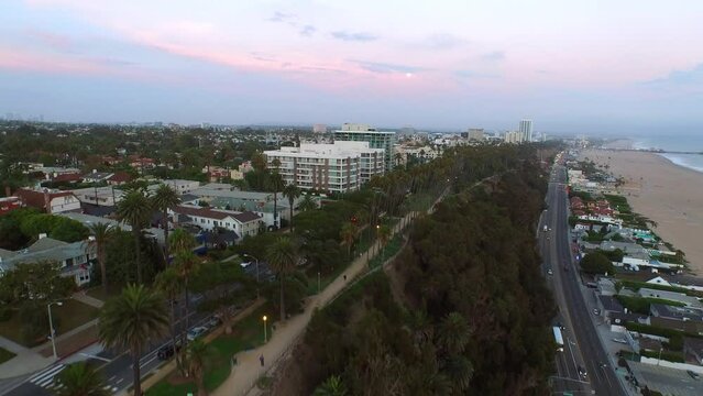Aerial Forward Scenic View Of Houses In City On Hill By Beach Against Sky - Santa Monica, California