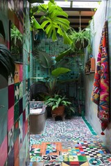 A tropical-themed bathroom with colorful mosaic tiles, lush green plants, and vibrant beach towels, Generative AI