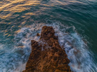 Top down sunrise over the sea and rock platform