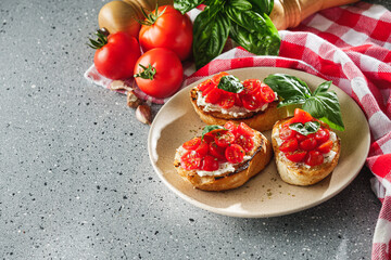 delicious Italian bruschetta with tomatoes on a light stone background