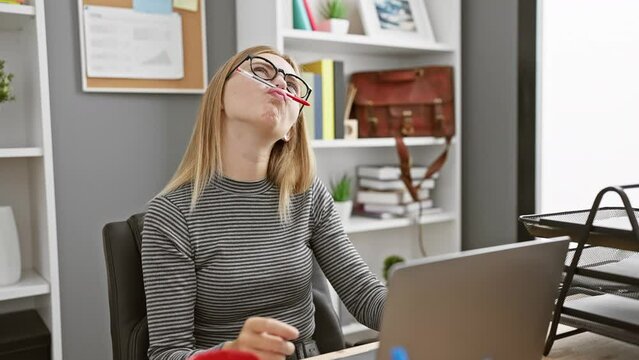 Caucasian woman with glasses making a funny face while working in a modern office
