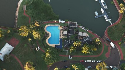 Aerial view of tourist complex and dock with boats on the shore of the Paraná River, Argentina