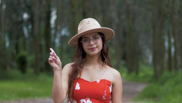 Not like this. A girl with a confident demeanor shows a raised finger in a warning gesture. Non-verbal communication conveying the need to stop and pay attention