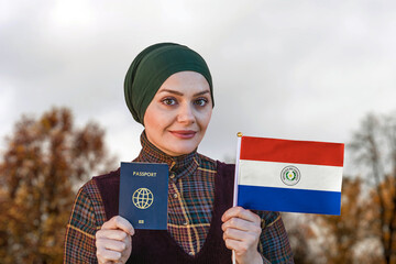 Muslim Woman Holding Passport and Flag of Paraguay
