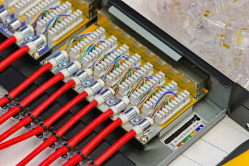 Patch panel with connected twisted pair wires. To connect an Ethernet signal in telecommunication...