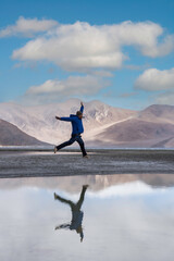 Male tourist standing and Traveler man enjoy Pangong Lake  Merak, Leh, Jammu and Kashmir ,India.