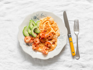 Delicious breakfast, brunch - omelette, shrimp, avocado on a light background, top view - 786834541