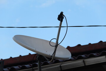Satellite dish on roof, satellite antennas mounted on the chimney