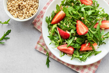 Fresh Strawberry Arugula Salad With Pine Nuts Served on a Bright Day