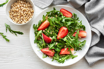Fresh Strawberry Arugula Salad With Pine Nuts Served on a Bright Day