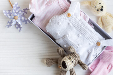 Baby clothes, knitted toys, socks  in box.