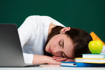 Student sleeping during a lecture in a classroom. Portrait of tired school girl lying and sleeping at desk during lesson. Tired bored teenage students in College, high school or university. - 786840329