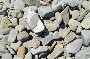 gray stones on the beach background, rough sandstone texture marble wallpaper. close up river brick...