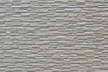 Exterior wall tiles of a building with a texture that appears quite hard