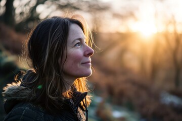 Portrait of a beautiful young woman in the forest at sunset.