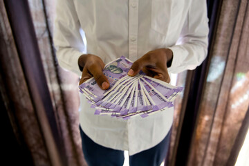 Close up of man hands Holding hundred rupees notes