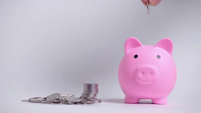 Save money and account banking for finance concept, Hand with coin and piggy bank on blurred background