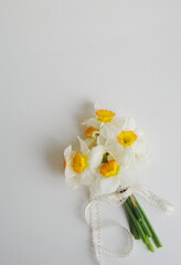 Bouquet of white and yellow daffodils on a white background. Top view, space for text, background, copy. Postcard, wedding, holiday, romantic concept