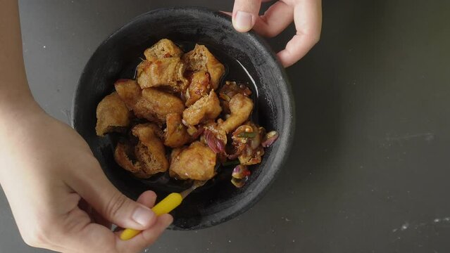 a portion of food from the city of Cirebon, Indonesia "Tahu gejrot" (fried tofu with sauce consisting of chili, garlic, shallots and sugar)