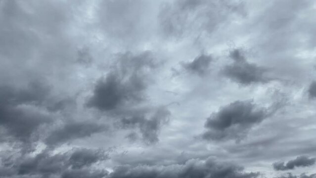 Gray, dark, gloomy, rainy clouds. Two bands of clouds dynamically pass each other. Time Lapse Video.