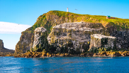 Mykines, Faroe Islands. Panoramic view of Mykines island, bird watching destination for puffins. Lighthouse at fjords landscape and seascape