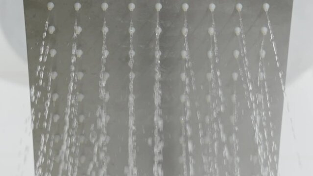 Shower of running water and hot steam. Rows of droplets. Household item