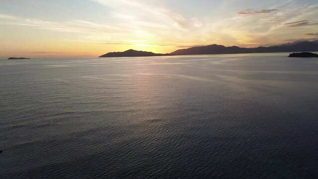 Aerial view of sunrise over the sea. flying over water into a beautiful sunrise