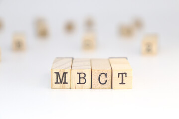 Mindfulness Based Cognitive Therapy MBCT written on wooden cubes
