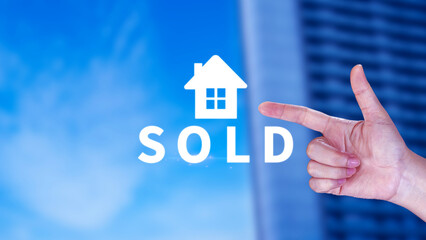 Fototapeta na wymiar Realtor's hand puts with icon house and word SOLD. Concept of selling house, apartment, real estate. market of immobility, Property investment and house mortgage financial concept
