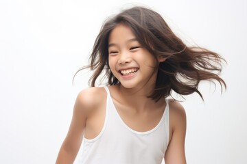 A beautiful Asian woman with long straight hair  whose skin is tan is wearing an all white shirt, and smiling with a face which is full of happiness in a white room. Generative AI.