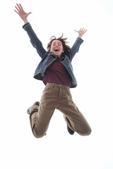 Woman with ecstatic expression jumping high, isolated on a white background.