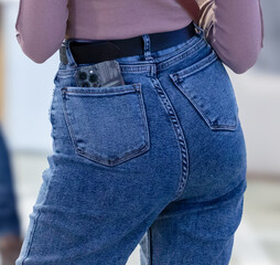Girl in jeans, rear view