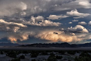 Dramatic sky with Rainbow near Dumont Dunes along Route 127 in the Mojave Desert, California