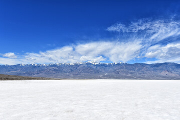 Badwater Basin, the lowest point in North America in Death Valley National Park, with the snowcapped Black Mountains in the distance. - obrazy, fototapety, plakaty
