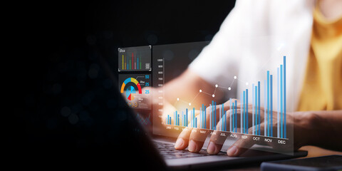 Data analyst working on business analytics dashboard with charts, with KPI and metrics connected to the database for technology finance, operations, sales, marketing