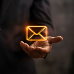 Businessman is holding virtual email symbol, message icon