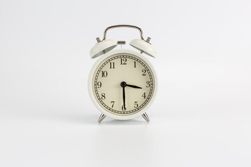 Retro white clock on a white background, the hands show the time at 15:30 or 3:30 AM or 3:30 PM