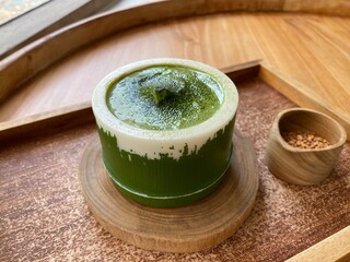 Matcha mousse cake serving in bamboo for Japanese dessert 