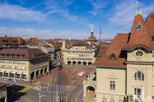 Bern, Switzerland - March 01 2023: Aerial of a tramway car that runs through the Casinoplatz square by the Casnio Bern in Switzerland capital city old town on a sunny day.