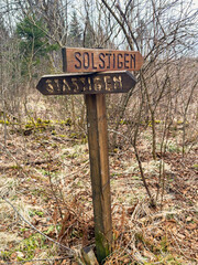Sign with names for different hiking trails in the forest
